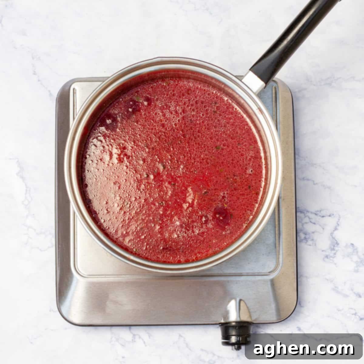 Plum-Glazed Pork Loin 6 Pork loin's plum sauce in skillet over flame