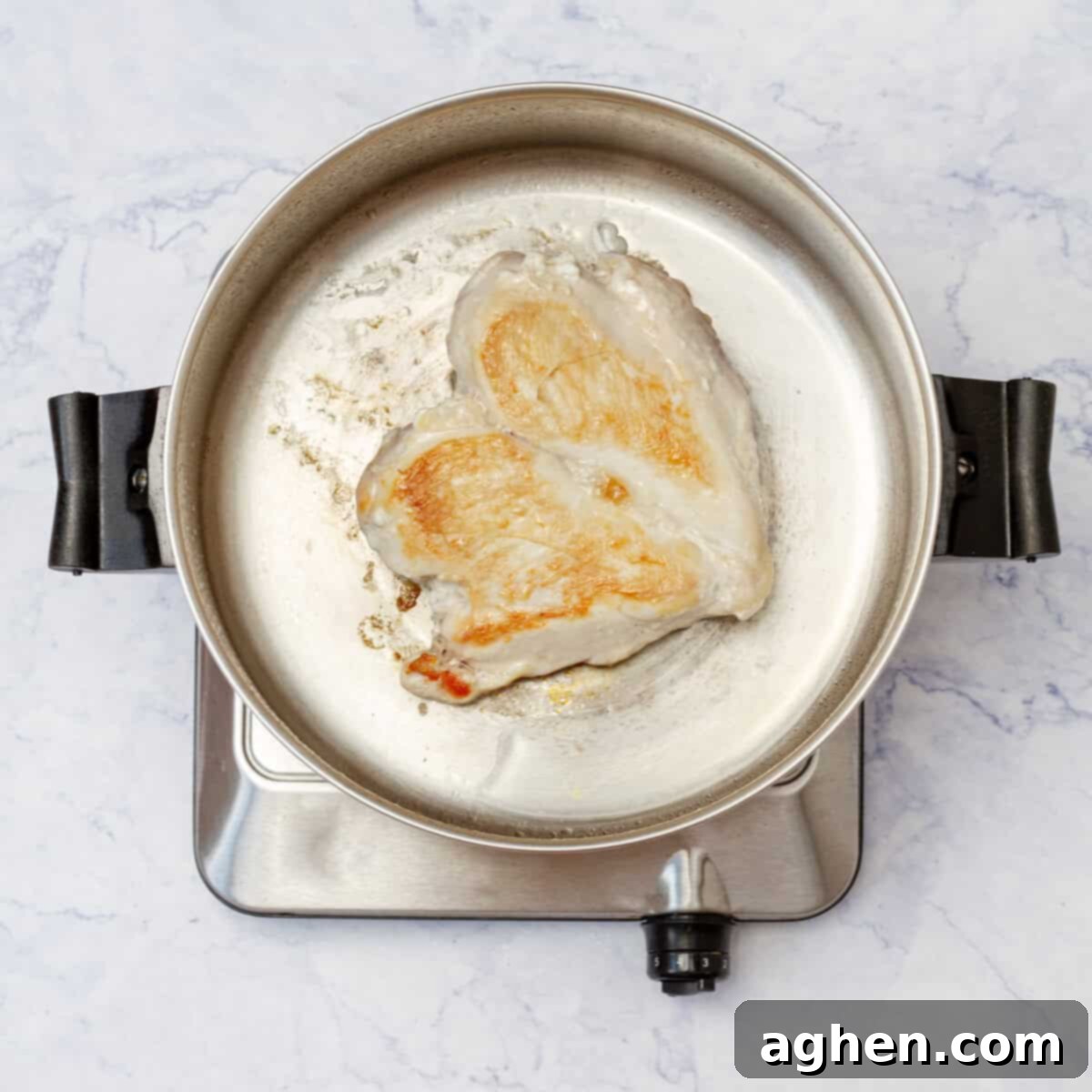 Light & Flavorful Asian Chicken Soup A Modern Take 4 Raw chicken breast browning in a hot skillet with oil