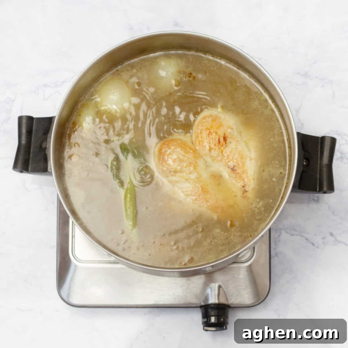 Light & Flavorful Asian Chicken Soup A Modern Take 5 Asian Chicken Soup broth simmering with aromatics like ginger, scallions, and onion