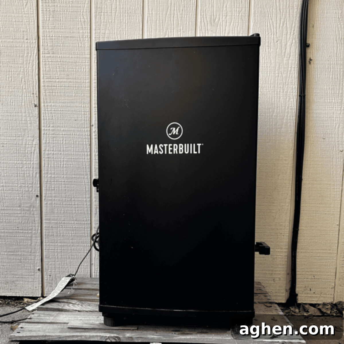 masterbuilt smoker sitting on homemade stand