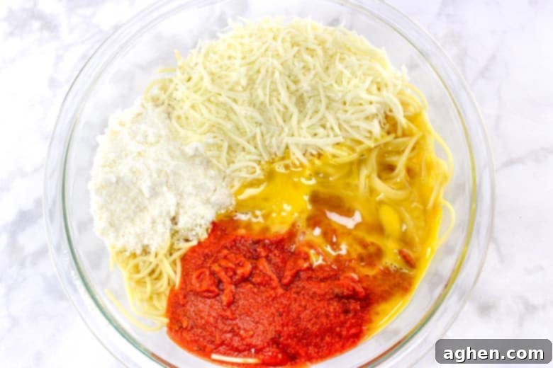 spaghetti, cheese, marinara, egg in glass mixing bowl, ingredients for meatball cups