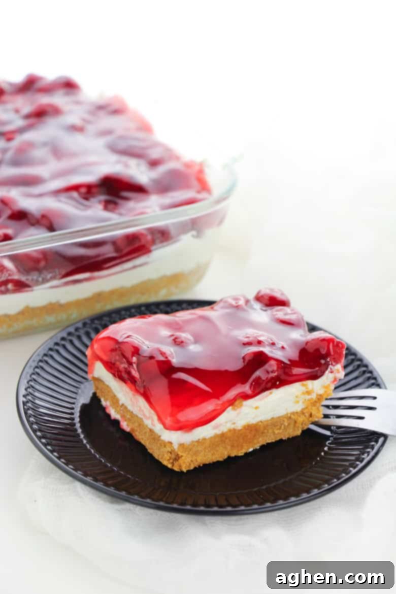 Delicious layered No Bake Cherry Cheesecake dessert ready to be served