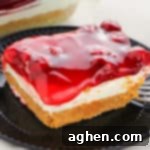 No Bake Cherry Cheesecake on a plate with a fork, showing layers