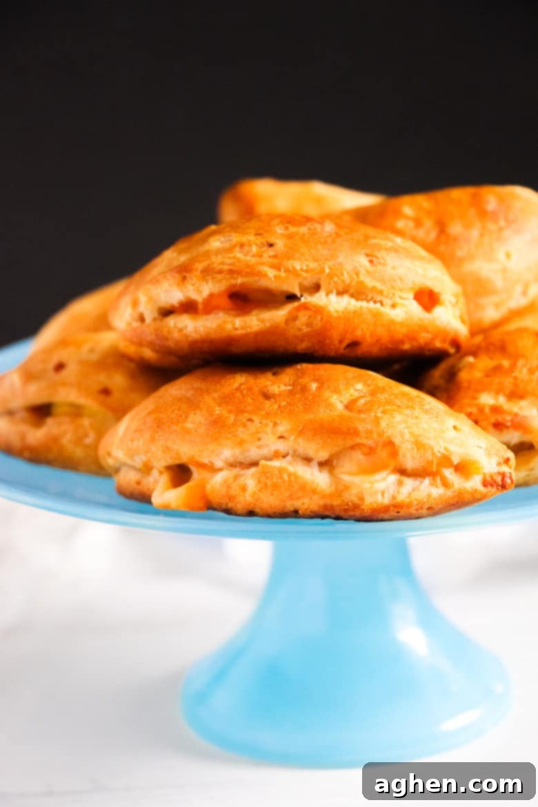Small calzones piled on blue cake platter