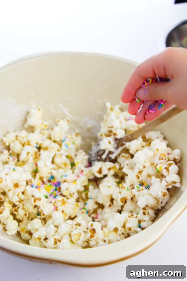 Adding sprinkles to bowl of popcorn