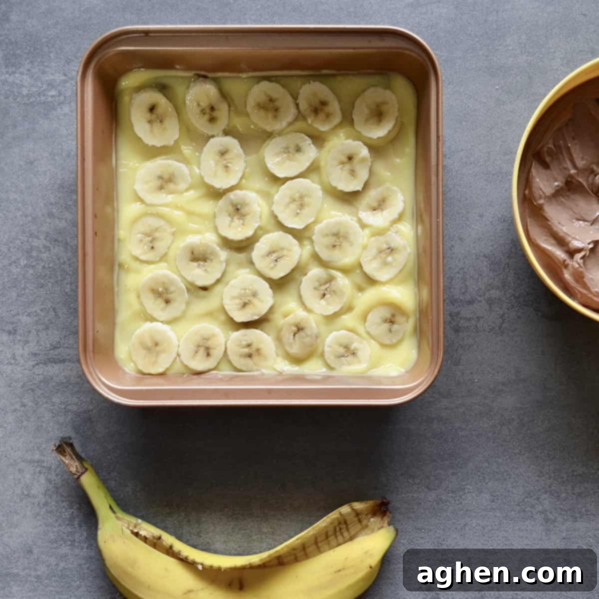 Thinly sliced fresh banana pieces embedded within a creamy banana pudding layer in the icebox cake
