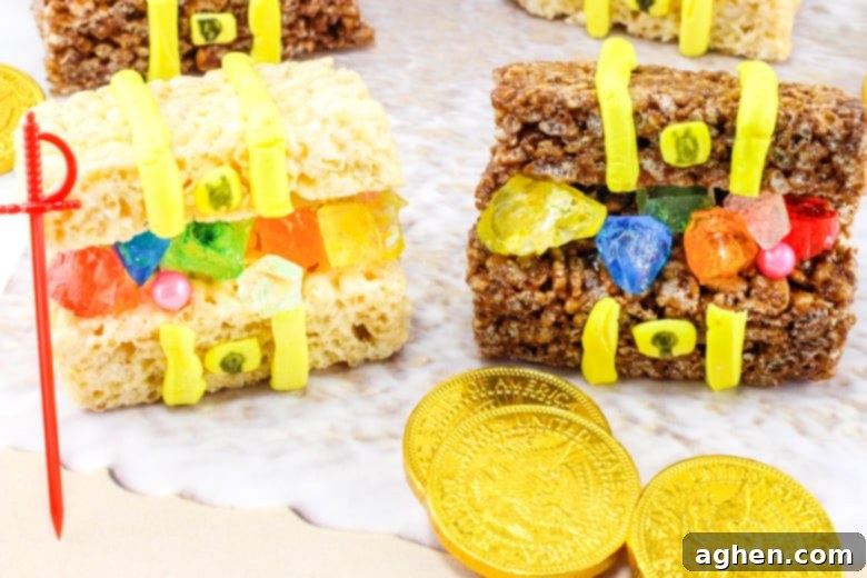 Two open treasure chests made from Rice Krispies treats, filled with rock candy, pearls, and other sweets.