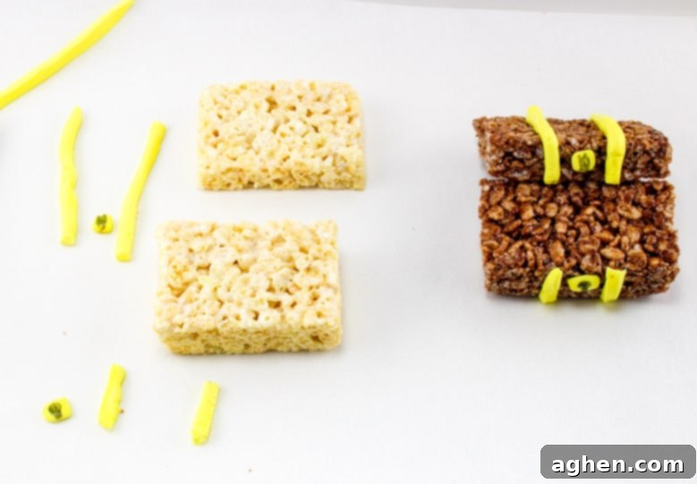 A Rice Krispies treat being adorned with strips of Laffy Taffy rope to resemble metal bands on a treasure chest.