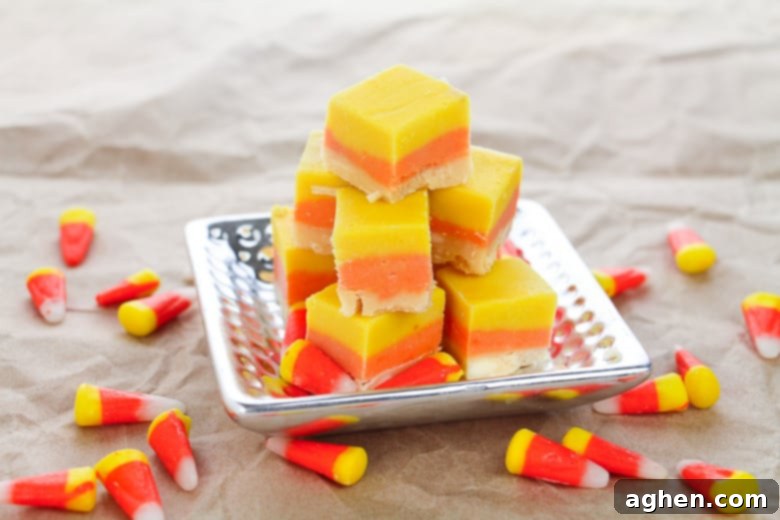 Candy Corn Fudge on a silver platter, with loose candy corn sprinkled around the table.
