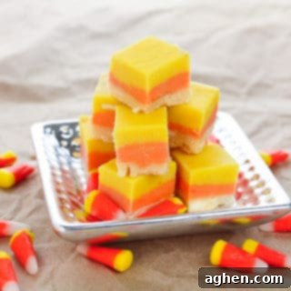 Candy Corn Fudge on silver platter, with candy corn sprinkled around the table