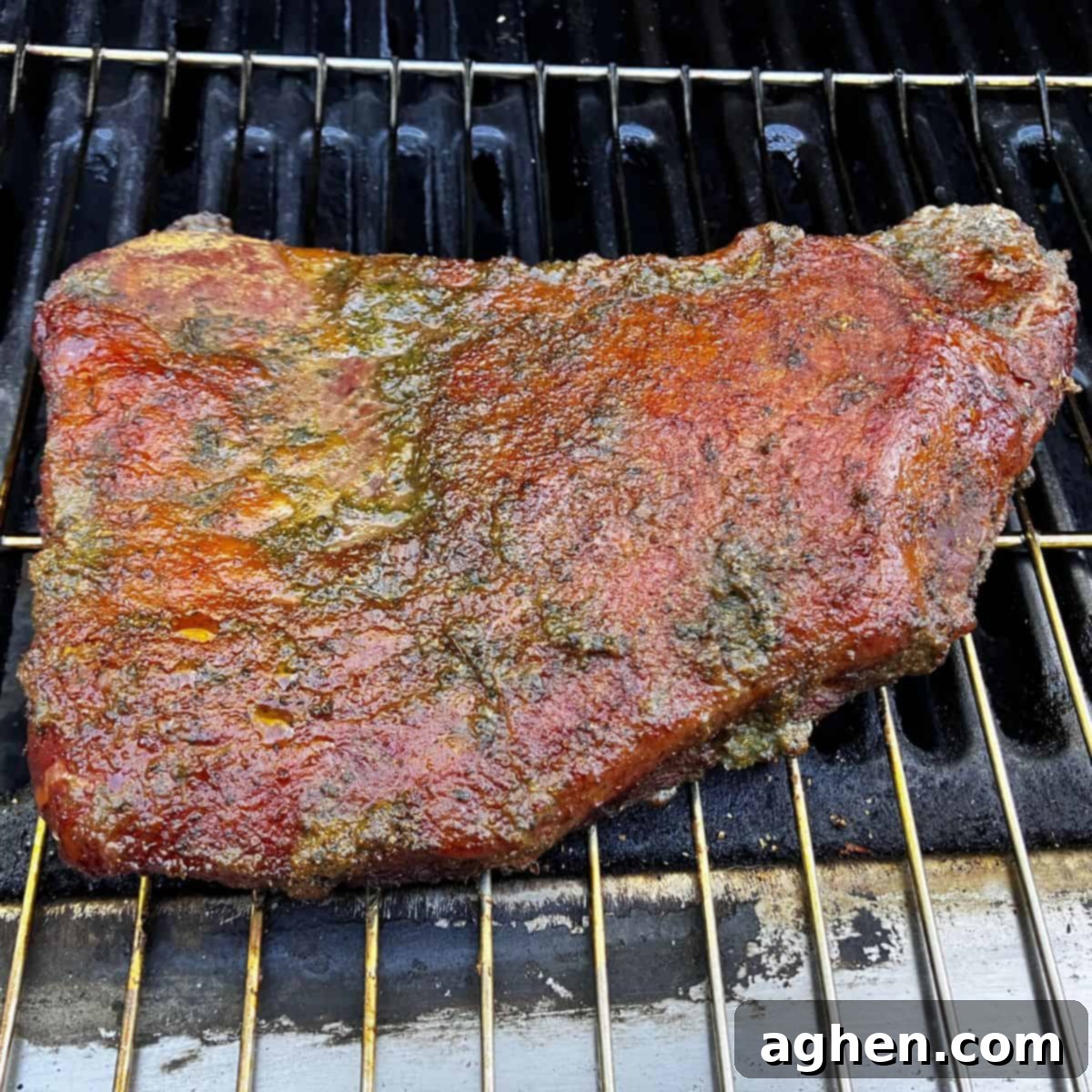 Tri-tip roast immediately after being removed from the smoker, showcasing a light crust and smoky hue, prior to searing.