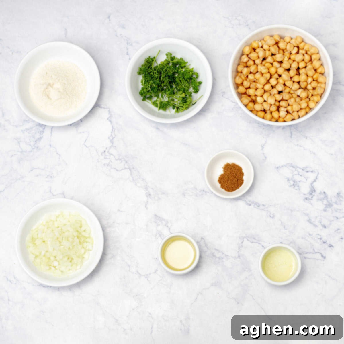 Simple falafel ingredients of chickpeas, fresh herbs, cumin, salt, onion, garlic, and lime juice. 