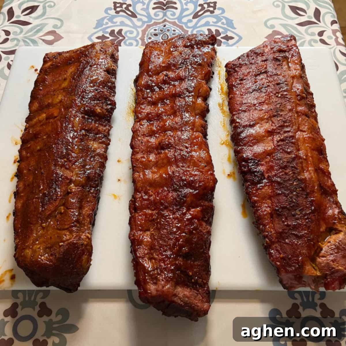 Award Winning Smoked Baby Back Ribs 2 Finished baby back ribs sitting on cutting board, perfectly smoked and glazed.