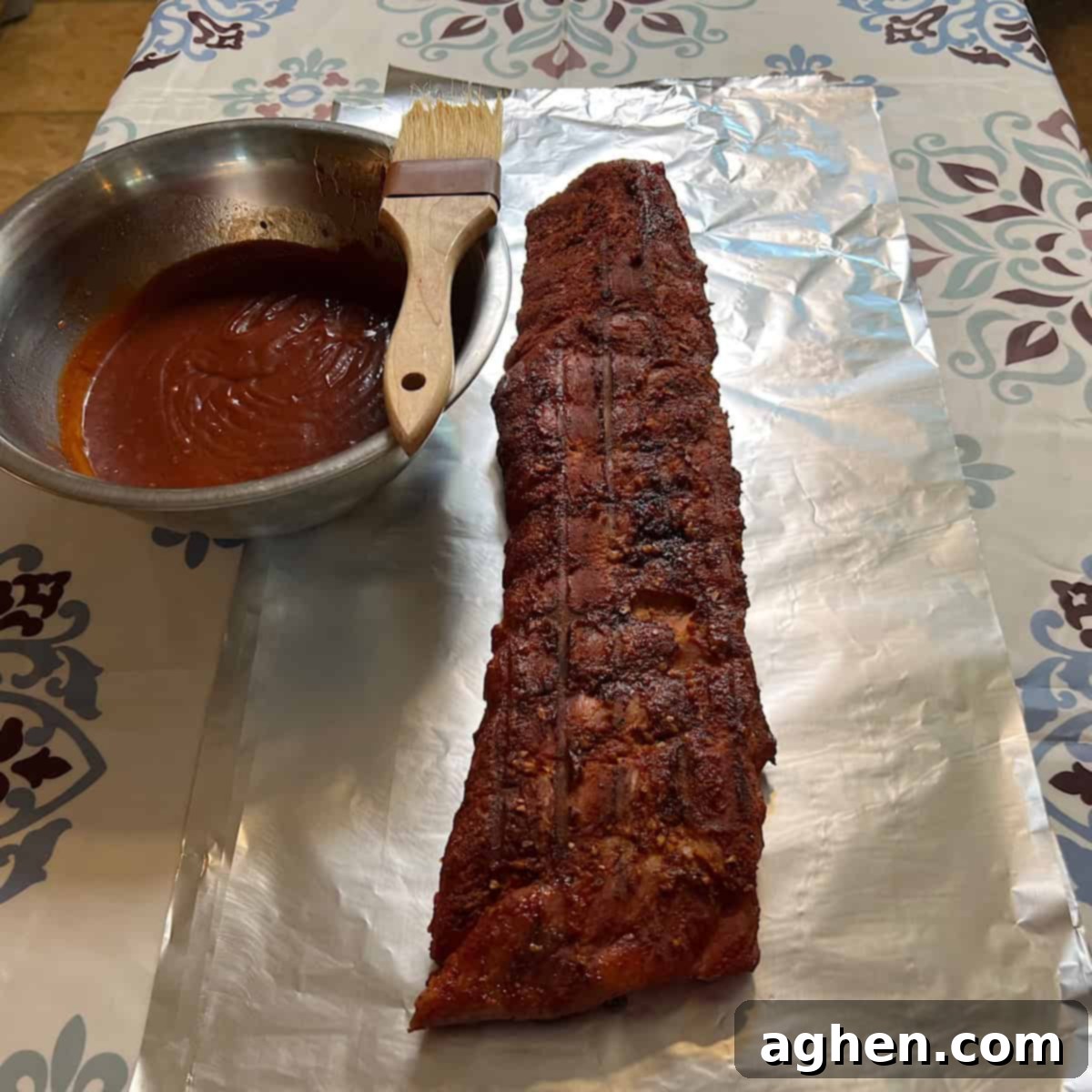 Award Winning Smoked Baby Back Ribs 10 Smoked ribs being wrapped in foil with BBQ sauce brushed on.