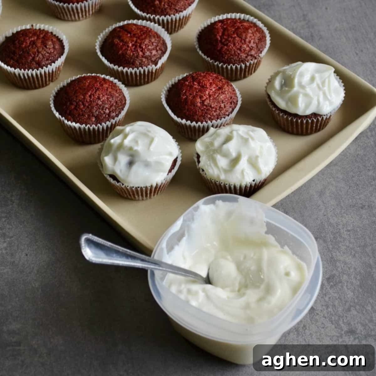Cream cheese icing and frosted red velvet cupcakes, ready for serving.
