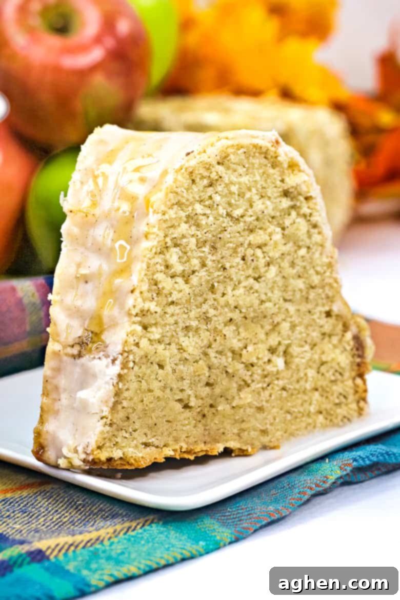 A close-up slice of Apple Cider Bundt Cake showing the moist crumb and glaze