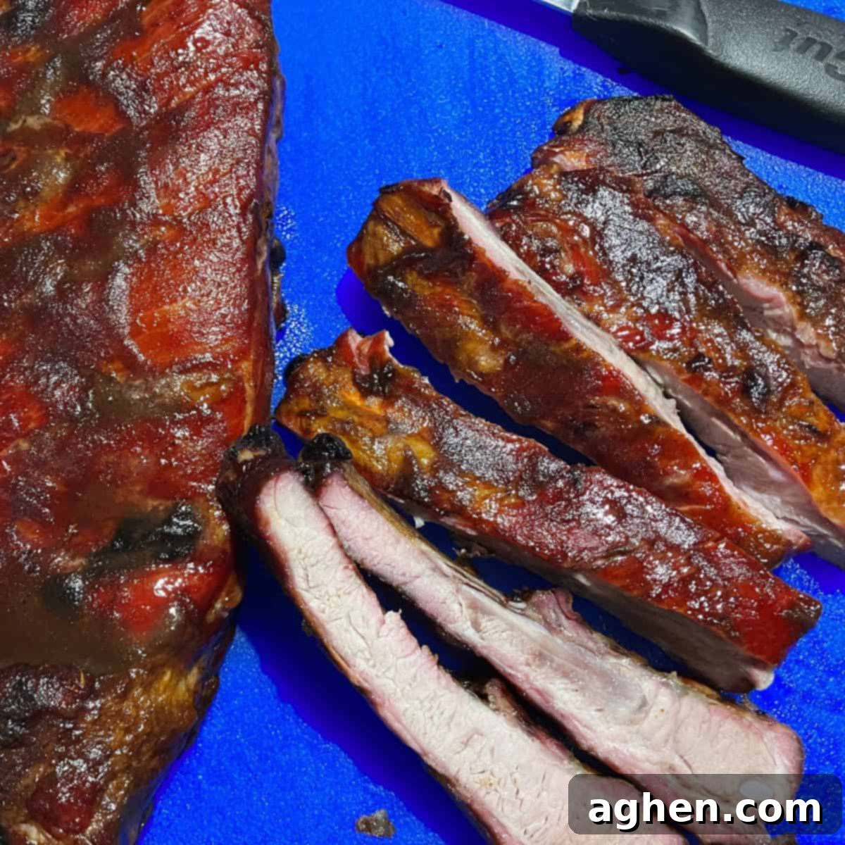 Masterbuilt Smoker Secrets for Irresistible Ribs 7 ribs ready to eat sitting on blue cutting board