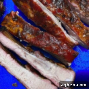 Masterbuilt Smoker Secrets for Irresistible Ribs 8 ribs cut and ready to eat sitting on blue cutting board
