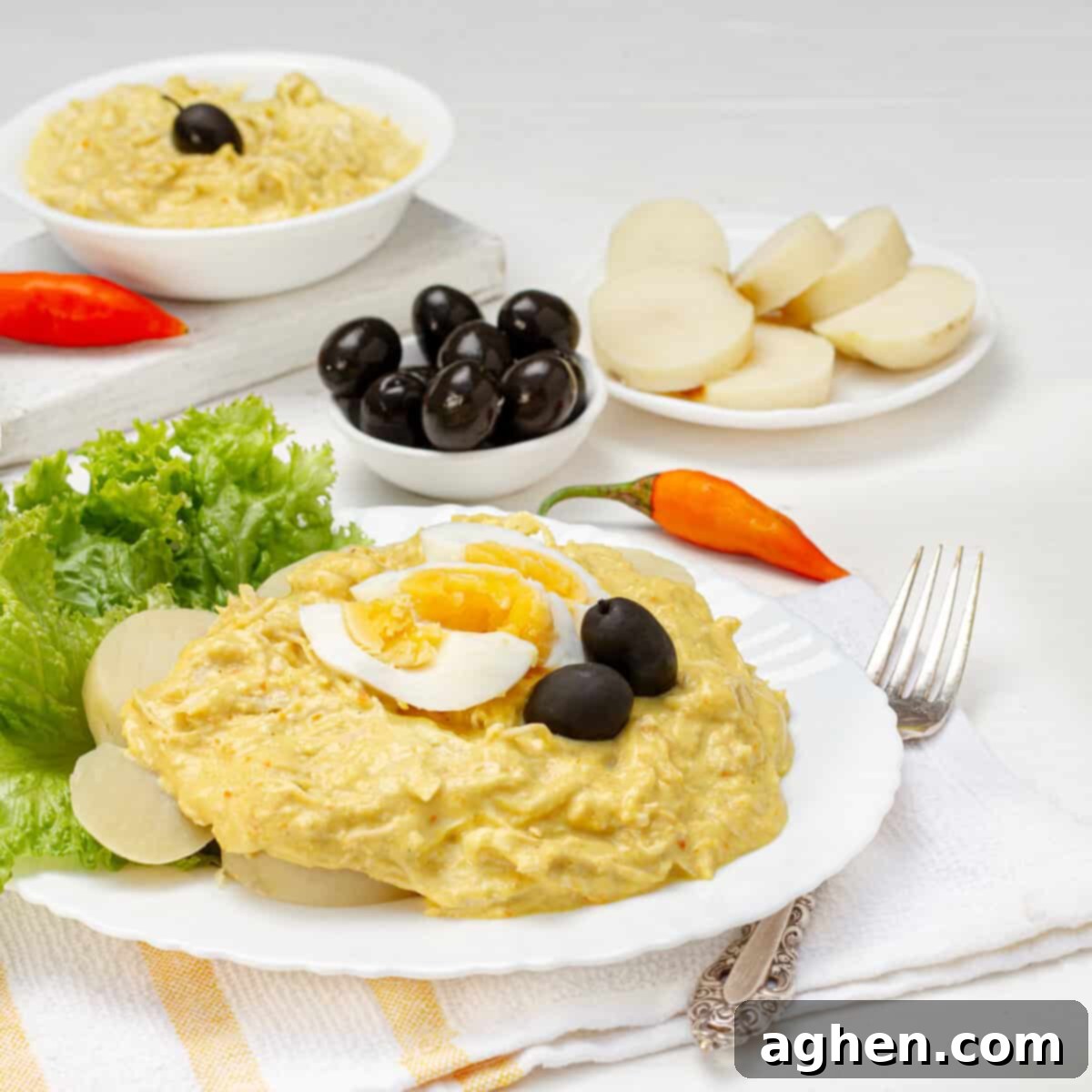 Rich and creamy Aji de Gallina from Peru, served with potatoes, rice, and eggs.
