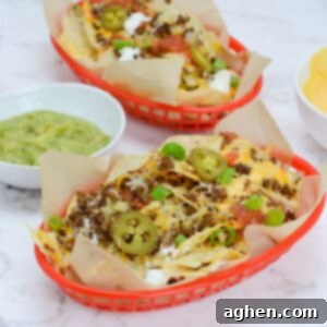 The Ultimate Blackstone Nacho Recipe 12 Two baskets of Blackstone nachos, loaded with a variety of delicious toppings for sharing.