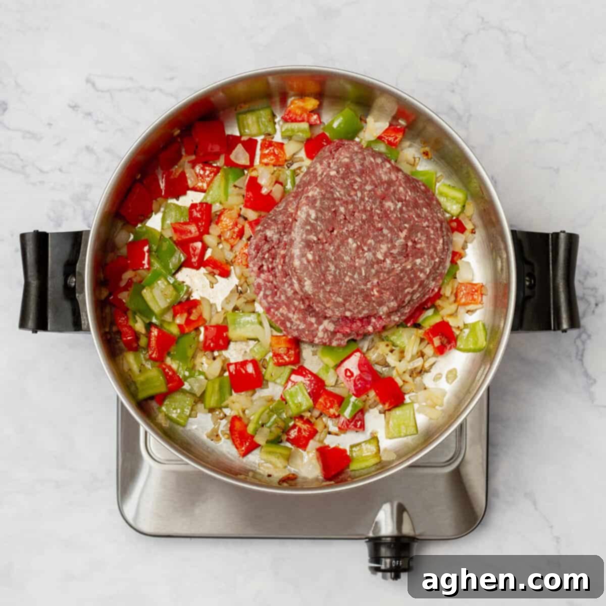 Stuffed Pepper Stew 4 Ground beef added to the pan with sautéed vegetables, mixing flavors.