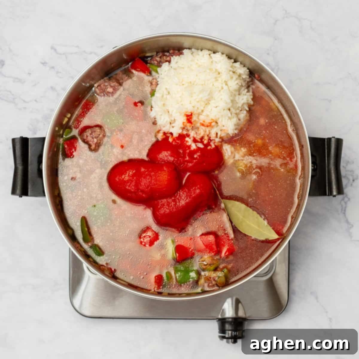 Stuffed Pepper Stew 5 Broth and diced tomatoes added to the sautéed vegetables and beef in the pot, ready to simmer.