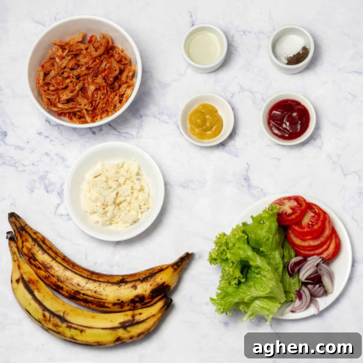 Stuffed Patacones ingredients of plantains, cottage cheese, stewed chicken, ketchup, mustard, red onion, lettuce, and tomatoes on separate dishes. 