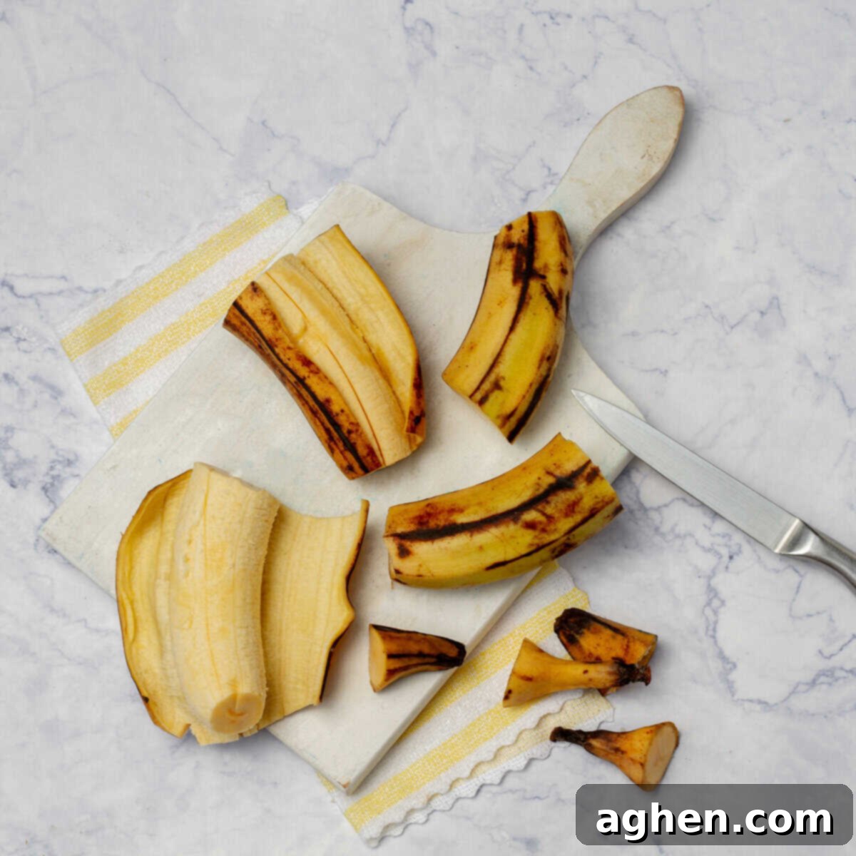 Pealed and trimmed plantains on a cutting board. 