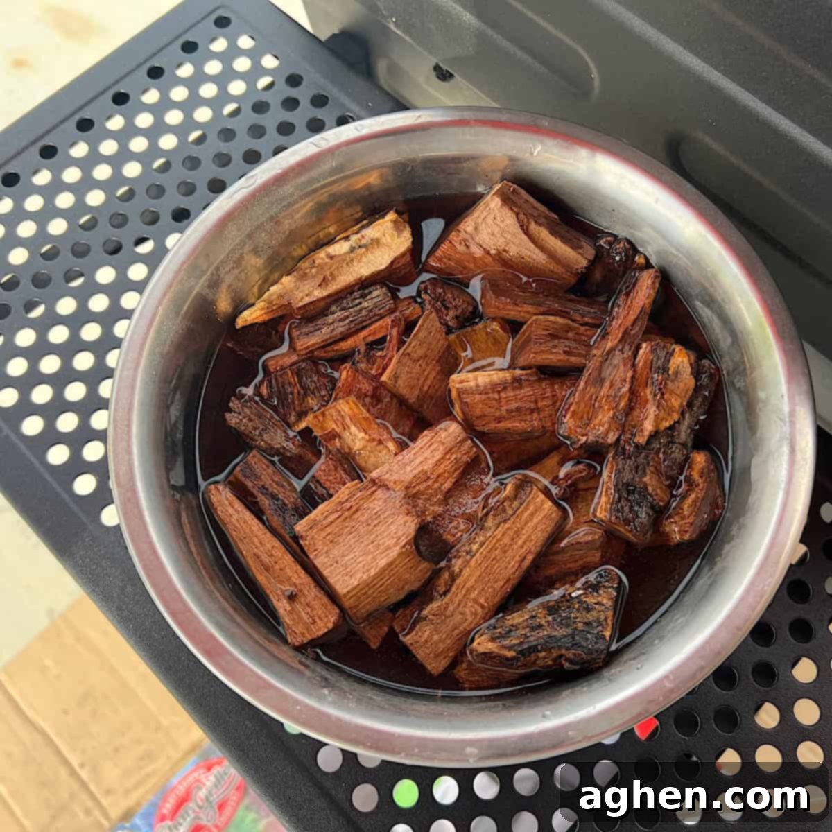 Your First Offset Smoker: Avoid My Biggest Mistakes 6 Wood chunks soaking in a bowl of water, preparing them for smoking.