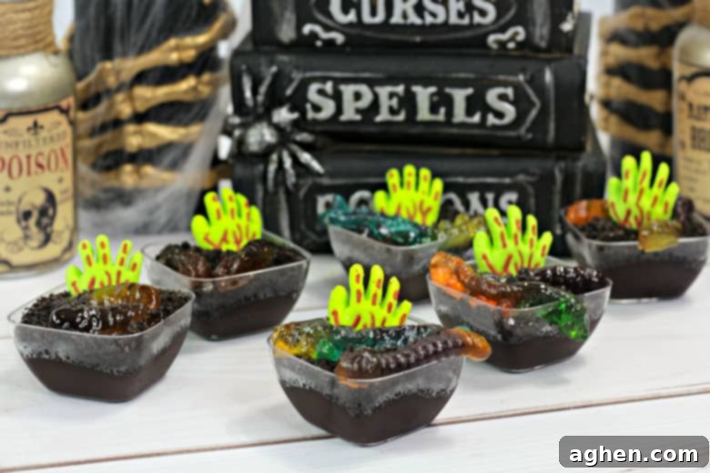Close-up of a Zombie Pudding Cup recipe showing the detail of the candy zombie hand and gummy worms in chocolate pudding