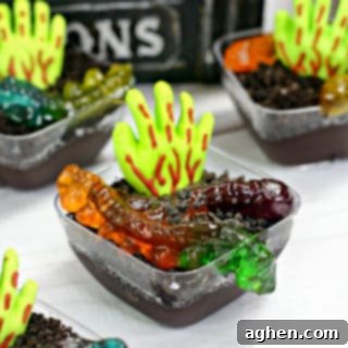 A close-up of a Zombie Pudding Cup, highlighting the candy hand and gummy worms