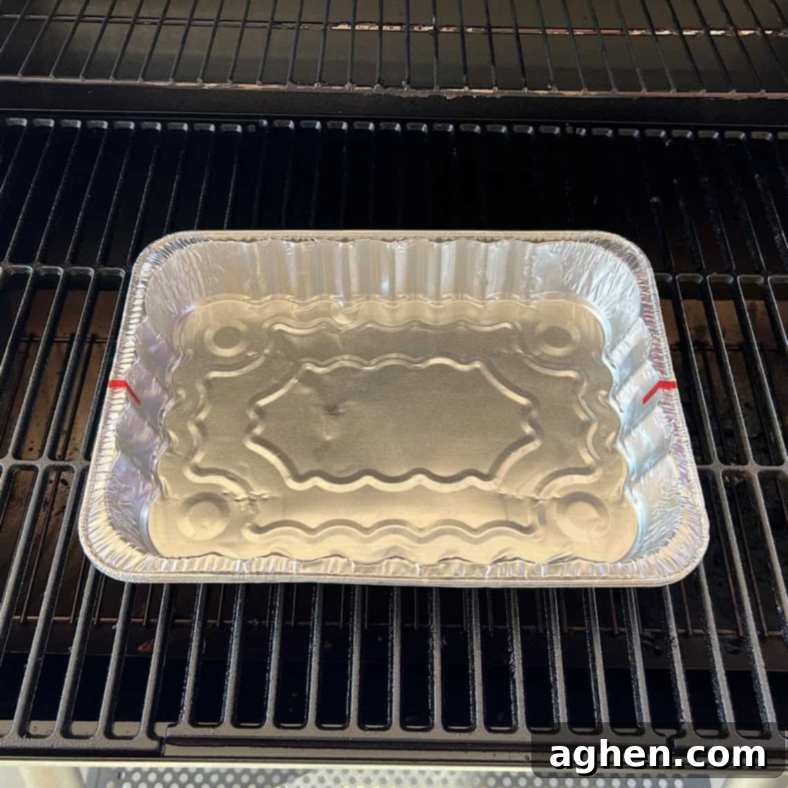 aluminum drip pan sitting on grill 