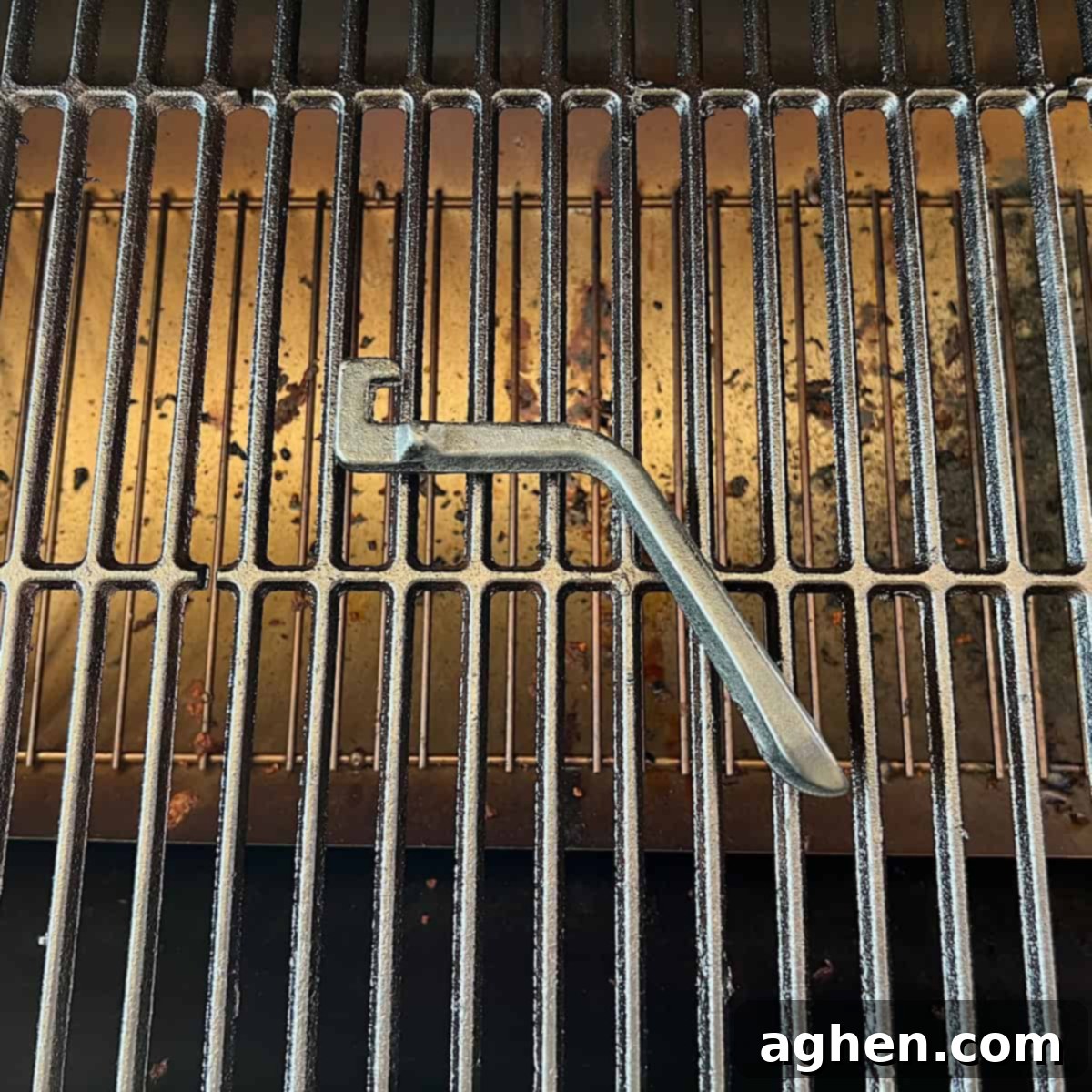 grill grate lifter sitting on grill 