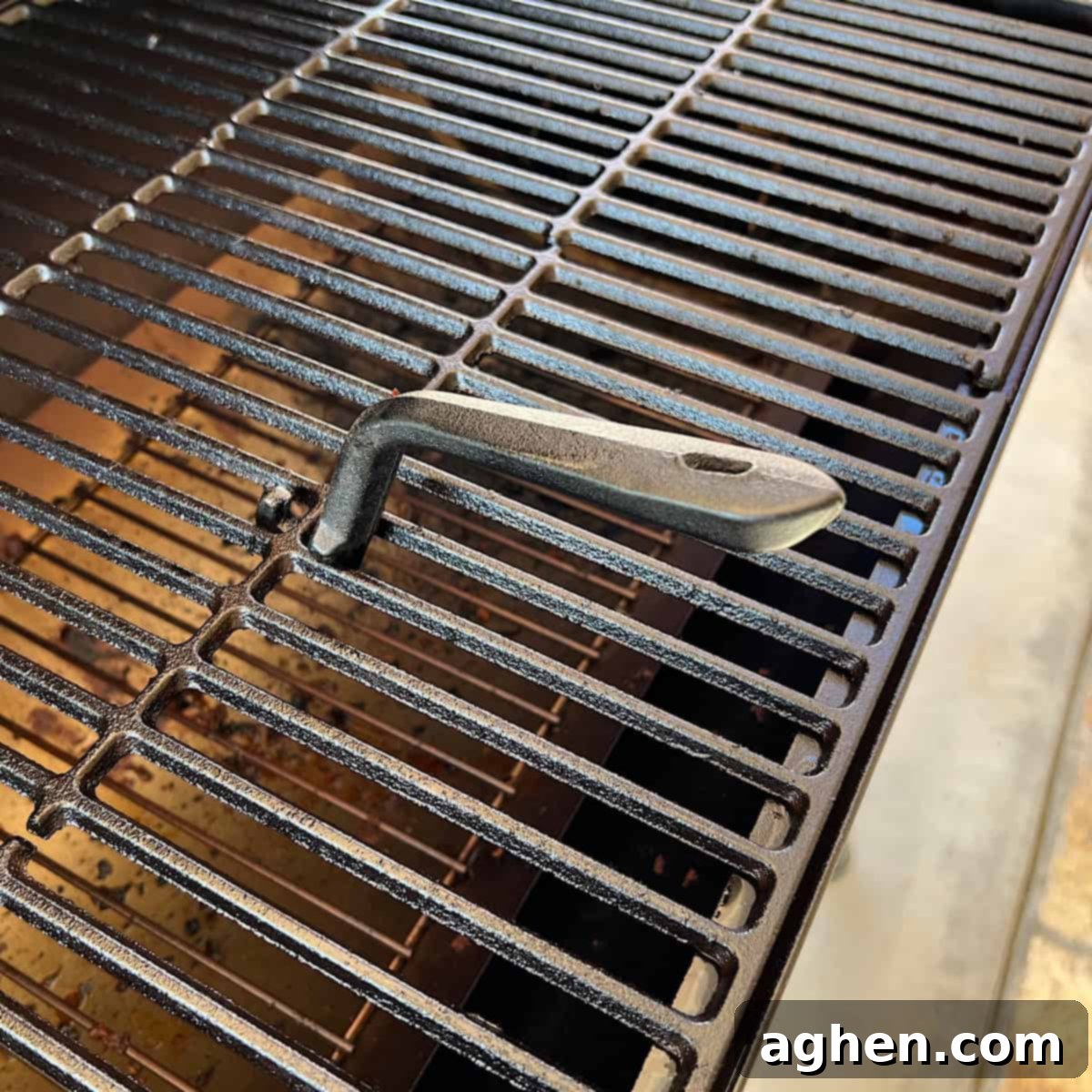grill grate lifter inserted into grill grate 