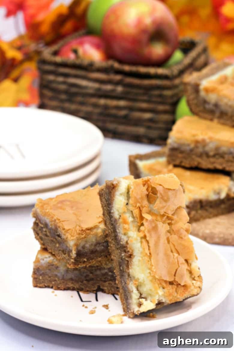 Delicious harvest spice bars on a plate, ready to be served, showcasing the creamy topping.