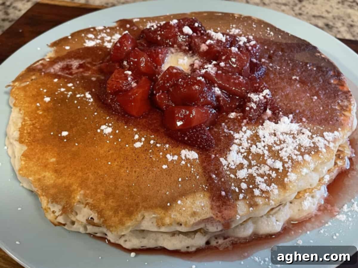 Blackstone's Jumbo Strawberry Pancakes: Every Kid's Dream 2 Blackstone griddle with a giant pancake pizza cooking on it