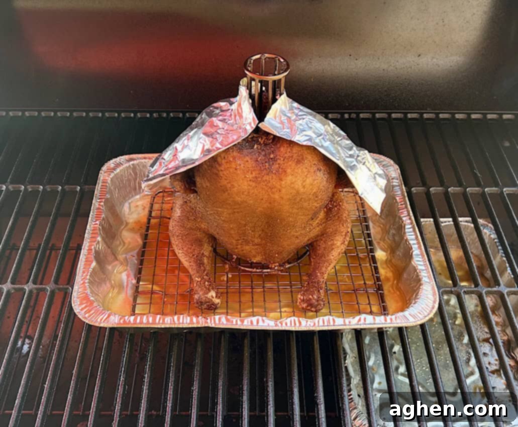 Smoked Standing Chicken No Beer 8 smoked chicken with foil cape protecting darker areas