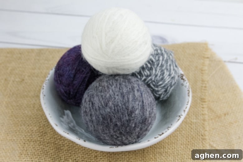 Stacked DIY wool dryer balls on a white plate, ready for use in laundry
