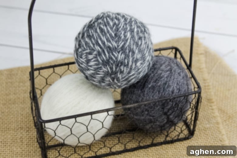 Finished DIY wool dryer balls resting in a rustic basket, ready for use in the laundry room