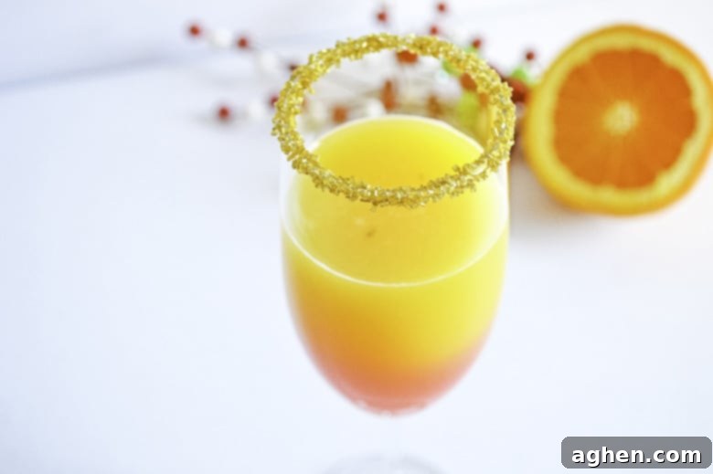 Christmas Mimosa Recipe in glass with festive garnish