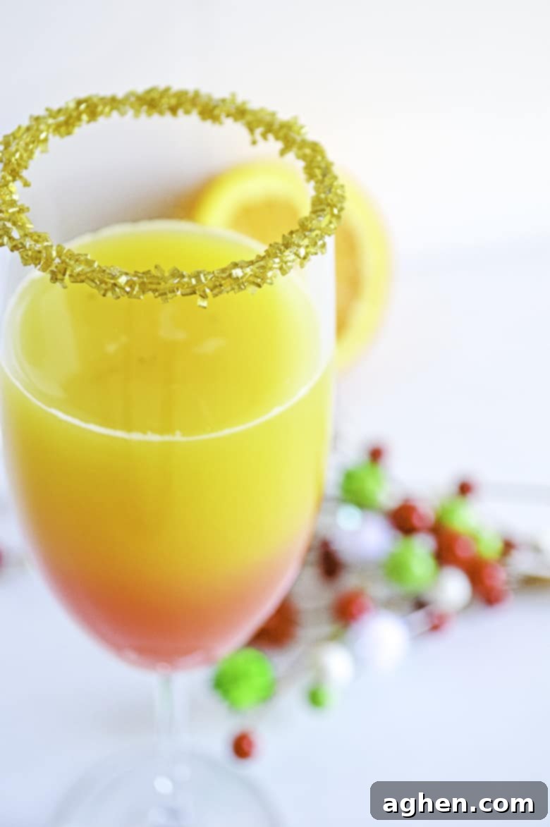 Christmas Mimosa recipe in champagne glass with festive garnishes