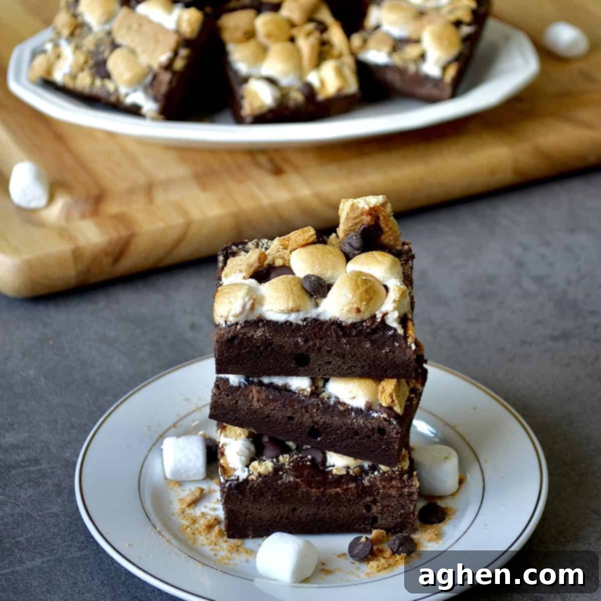 Stack of gooey, fudgy s'mores brownies with toasted marshmallows and chocolate chips
