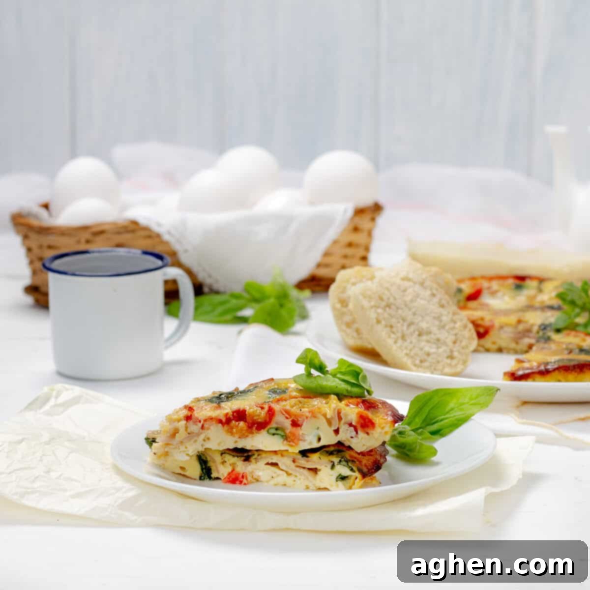 Spinach, Tomato, and Turkey Ham Frittata slices on a plate, garnished with fresh herbs.