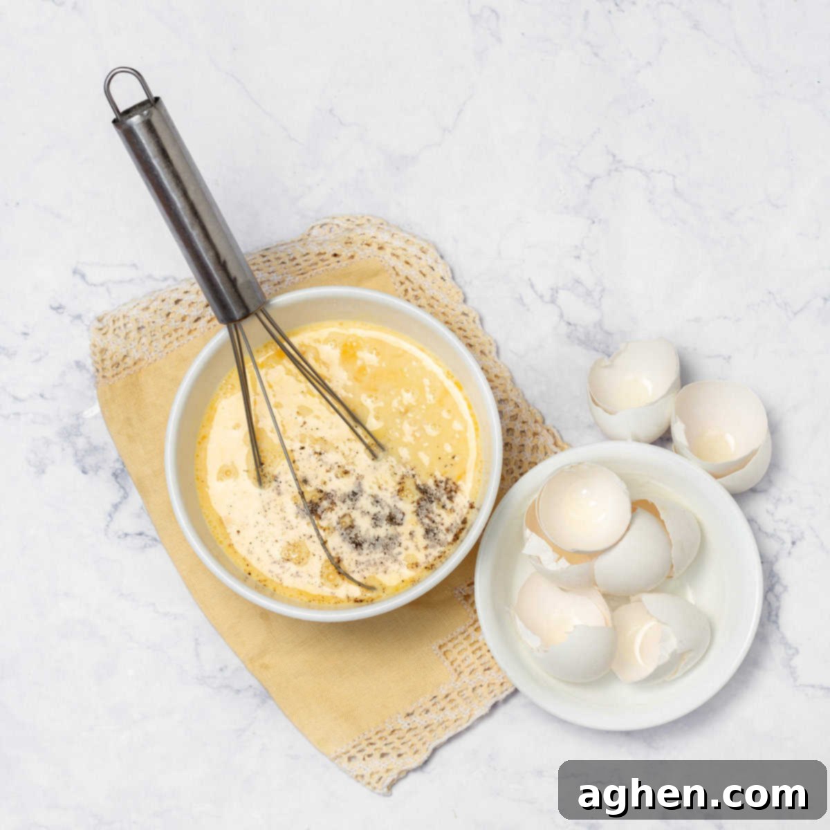 Whisked eggs in a bowl with seasonings, ready for the frittata.