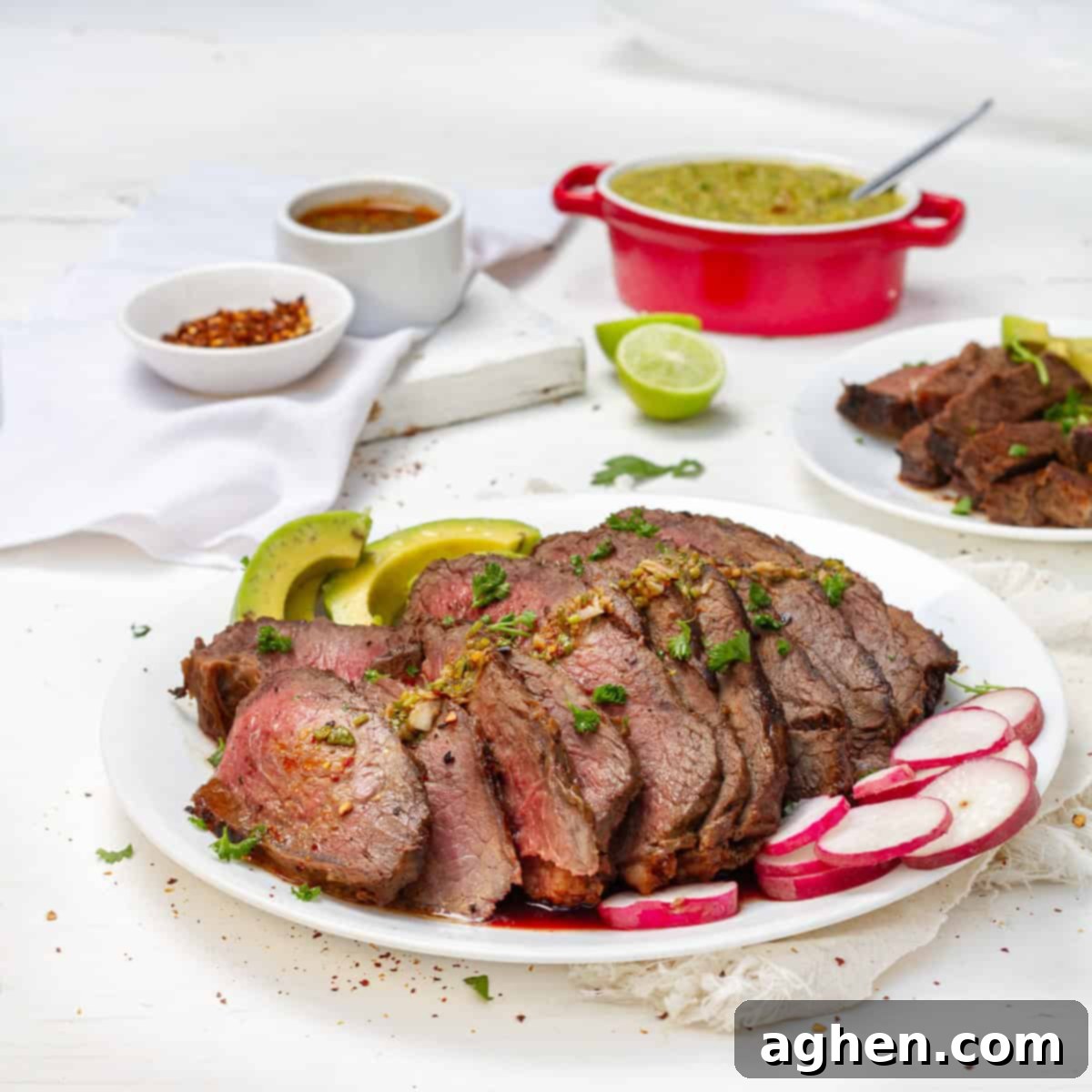 The Ultimate Weight Watchers Carne Asada 2 Tender and flavorful carne asada sliced on a platter with fresh radish.