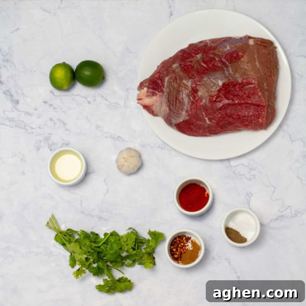 The Ultimate Weight Watchers Carne Asada 3 Carne asada ingredients of round steak, fresh cilantro, seasonings, limes, and oil in separate dishes.