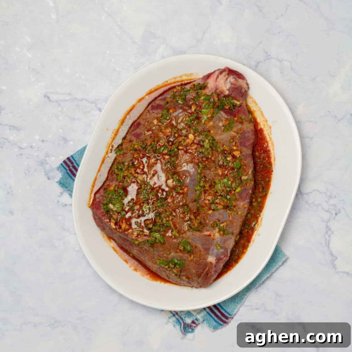 The Ultimate Weight Watchers Carne Asada 6 The marinated round steak on a plate ready for cooking.