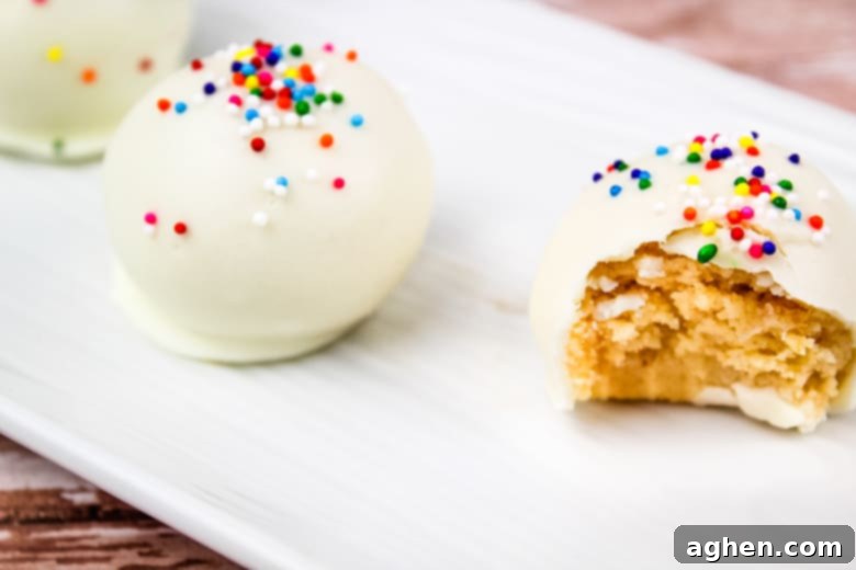 Plated sugar cookie truffles with white chocolate coating and colorful sprinkles.