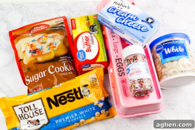 A selection of sugar cookie truffle ingredients including sugar cookie mix, cream cheese, vanilla frosting, and white chocolate chips.