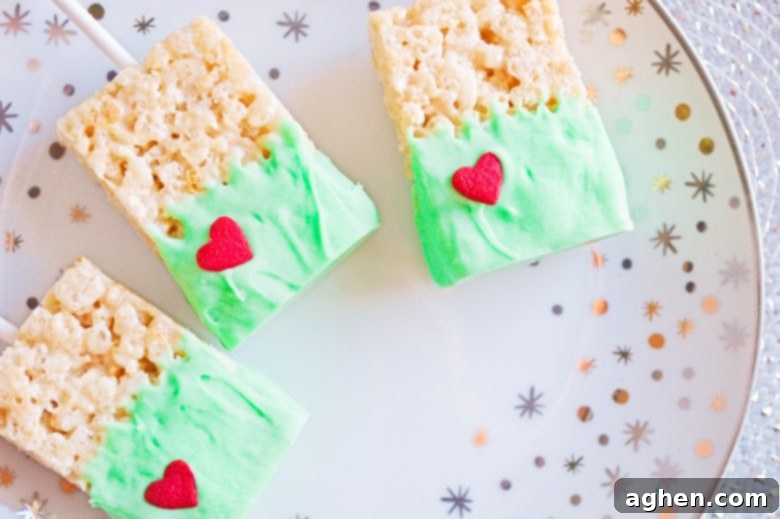 Grinch Snacks, a plate of green Rice Krispie treats with red hearts